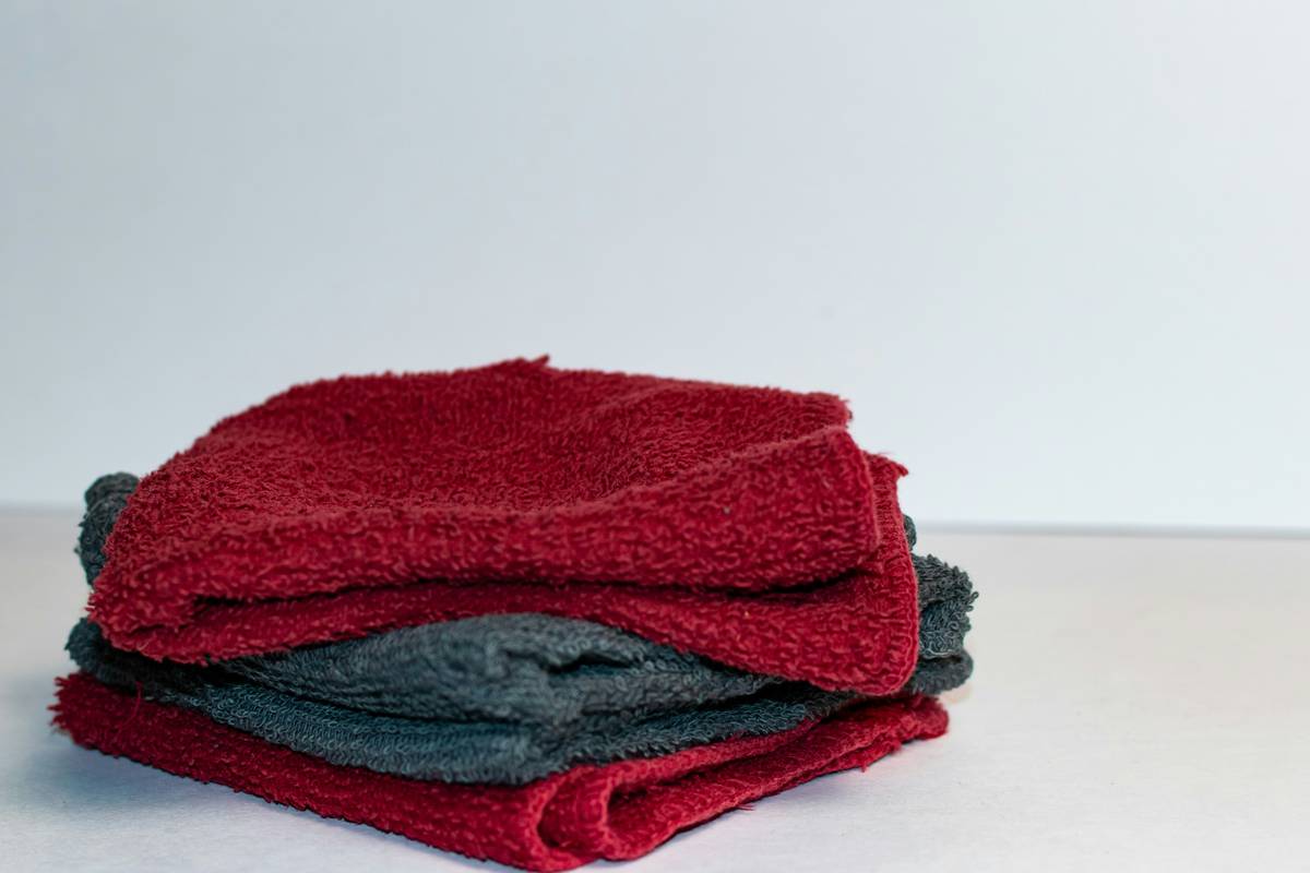 Close-up of green scrubbing pads nearby on kitchen counter with reusable mop