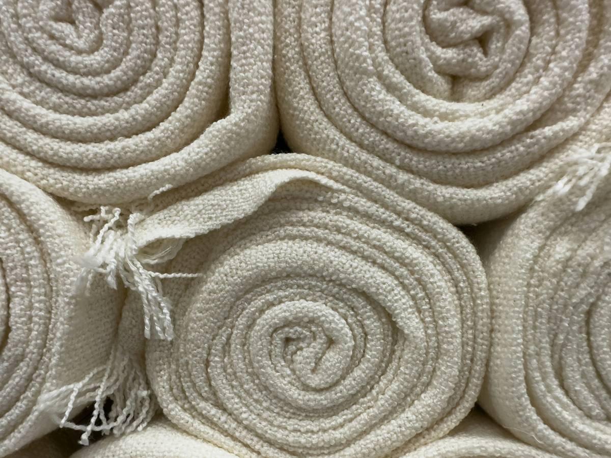 Close-up of dirty Bona mop pad next to a washing machine with text: are bona mop pads washable